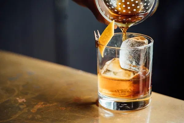 Craft cocktail being prepared in a sophisticated London bar