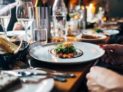 Premium London dining scene with plated food and wine
